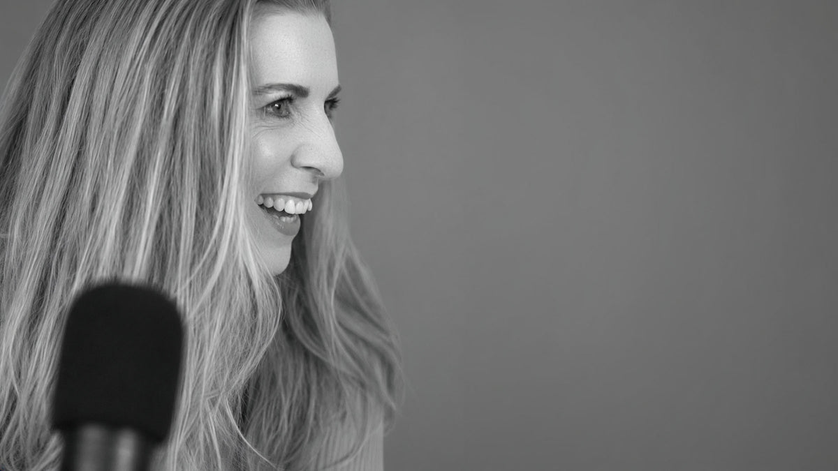 Image of Emma Hindmarsh Conan - SomeplaceGood founder talking into a podcast microphone